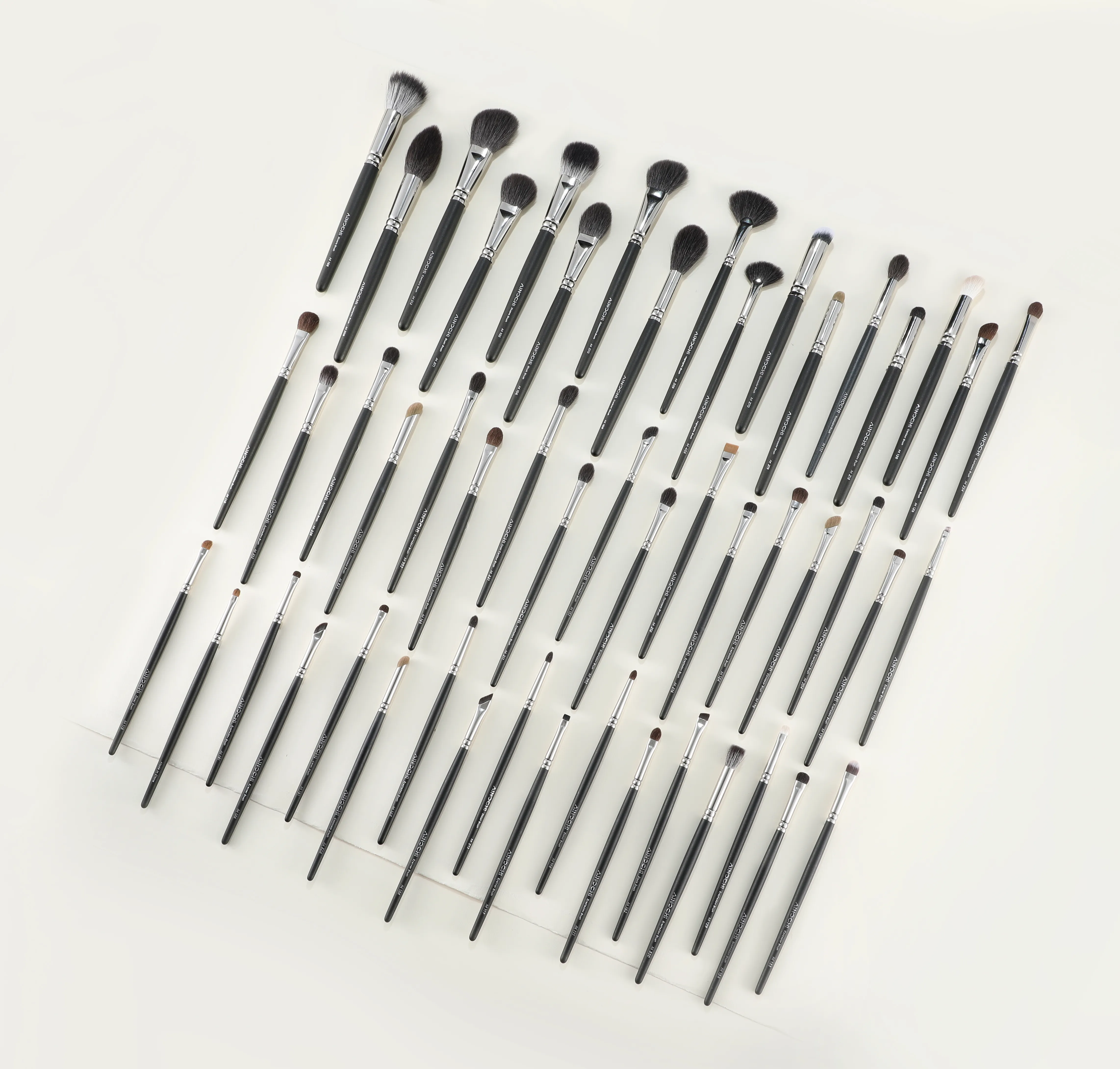 Black professional makeup brush collection with varied face and eye heads