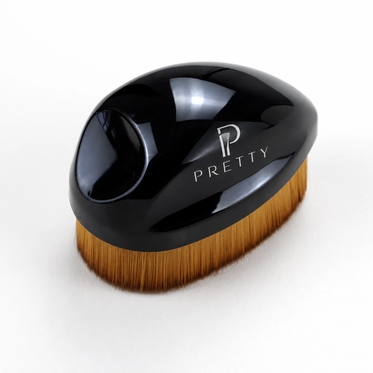Black palm brush with recessed grip and a broad golden bristle surface
