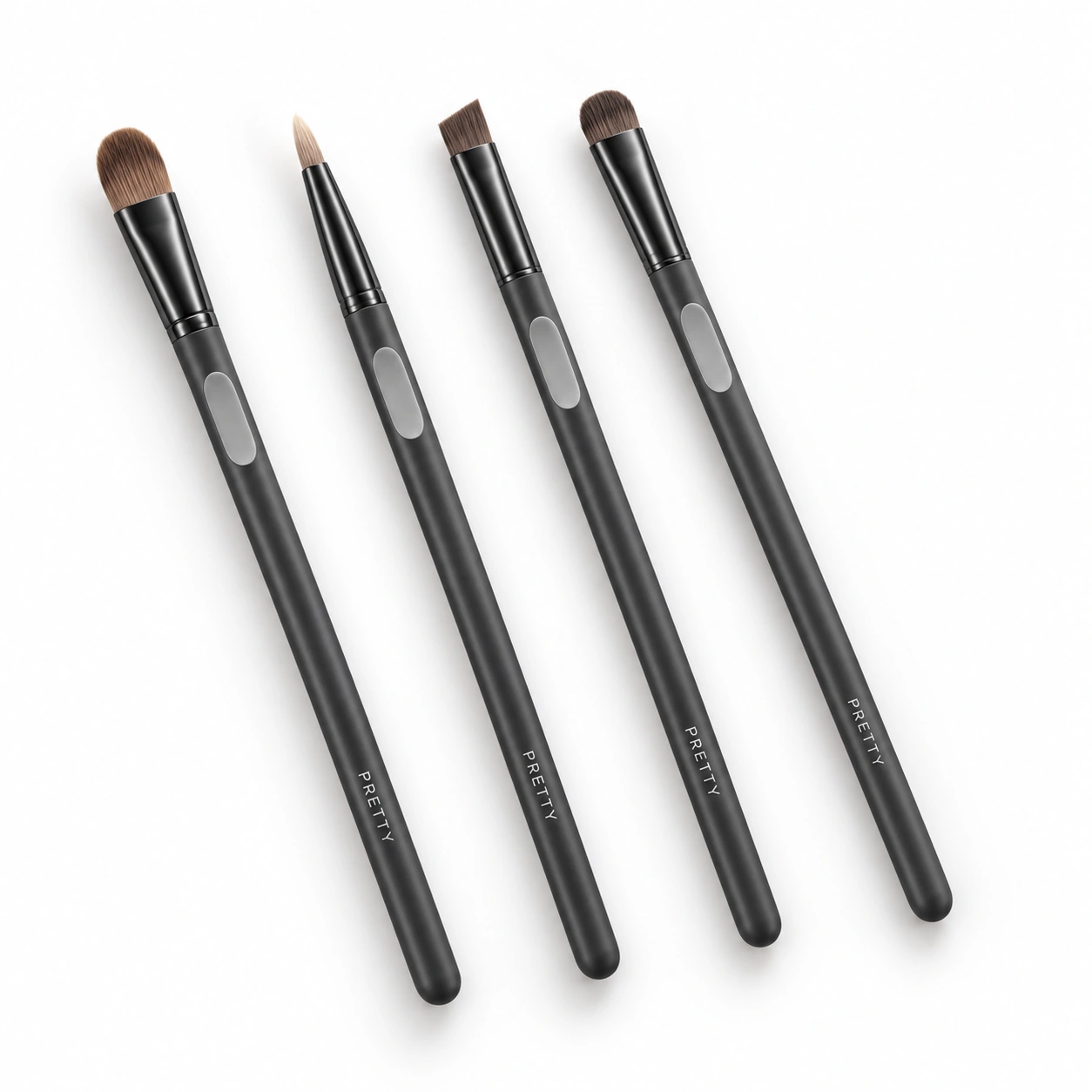 Graphite Precision: Four small brush heads with long graphite-tone handles and contrasting pale grip areas. A study in placement, control and clear visual organisation. Original design concept.