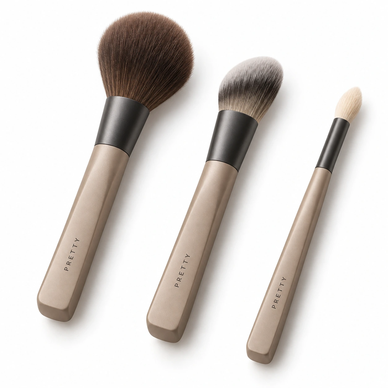 Sandstone Studio: Three face-brush profiles with sand-tone handles and graphite-tone ferrules. Flat handle planes explore how a brush is held and set down. Original design concept.