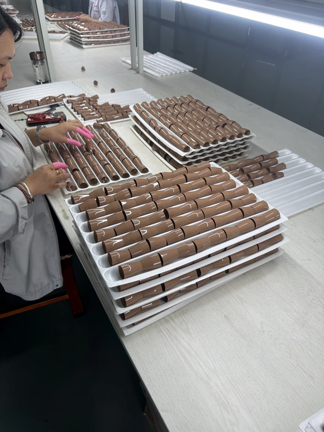 Ferrule components photographed at a manufacturing workbench