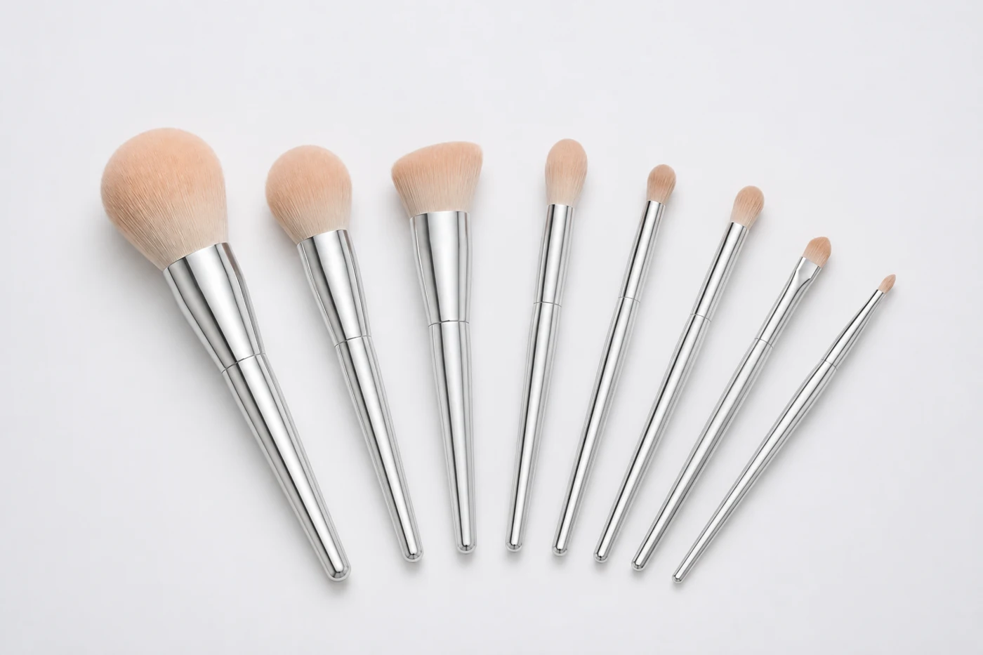 Eight silver brushes arranged as a coordinated development concept