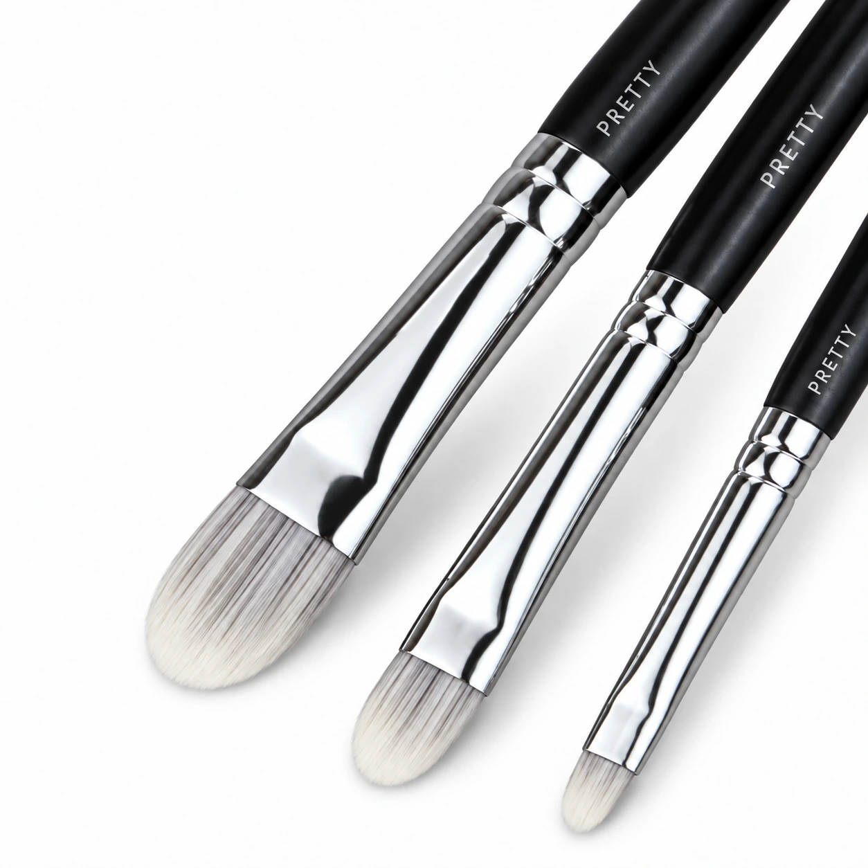 Three pale rounded-flat heads with cropped dark handles, produced brush design