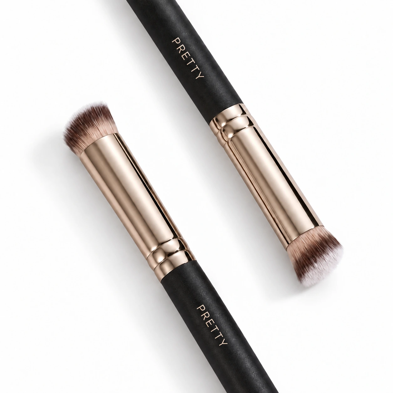 Two cropped dark-handle brushes with short brown-white heads, produced brush design