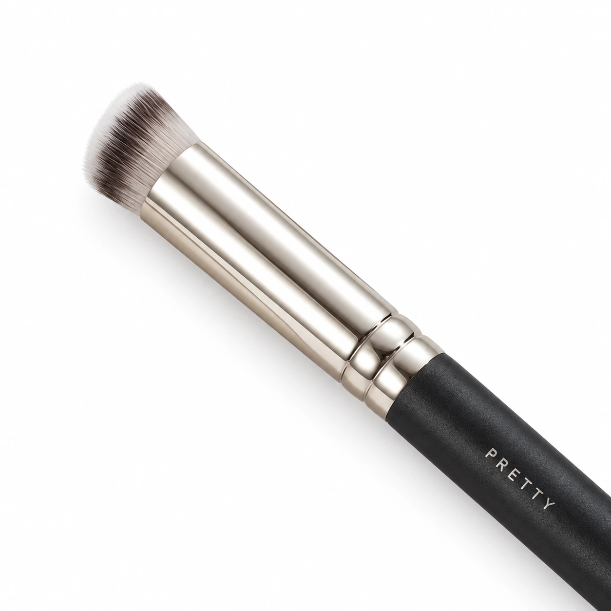 Cropped dark-handle brush with a short angled brown-white head, produced brush design