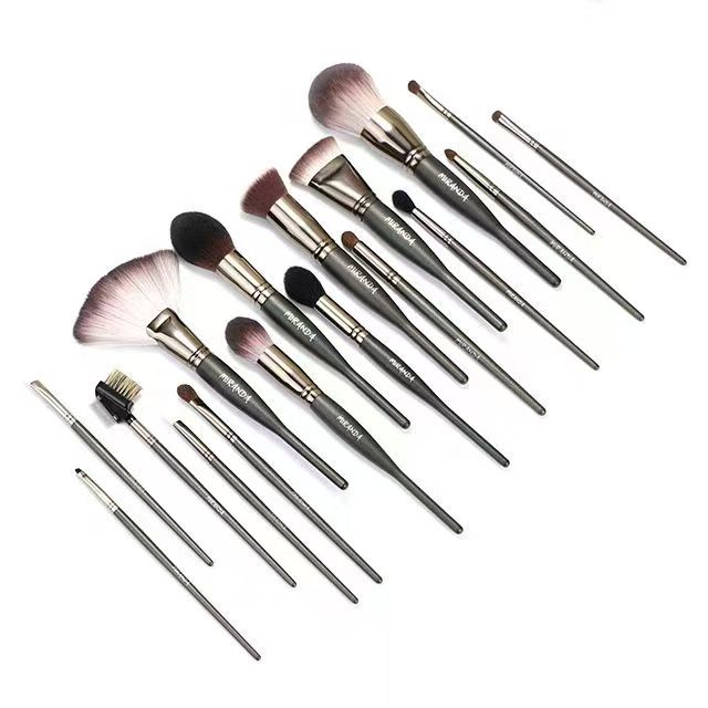 UP024: Seventeen dark-gray tools with varied brush heads and a comb