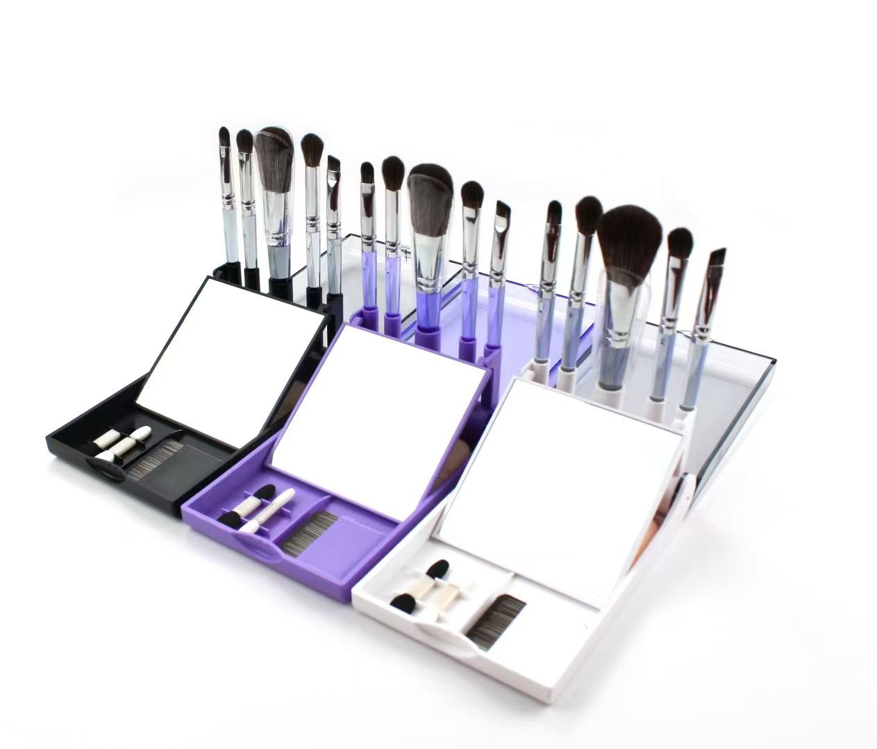 UP032: Three open mirrored travel cases with five brushes each