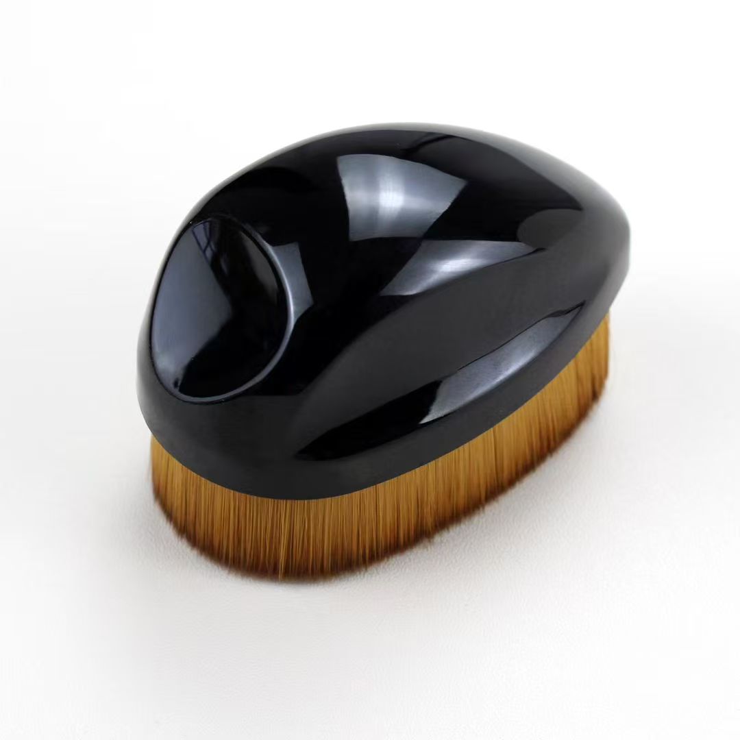 UP048: Black palm-grip brush with a recessed grip in an alternate view