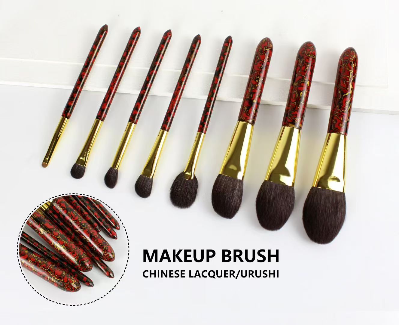 UP062: Eight red-and-black patterned brushes with gold-tone ferrules