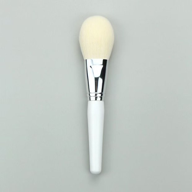 White-handle brush with a broad pale oval head