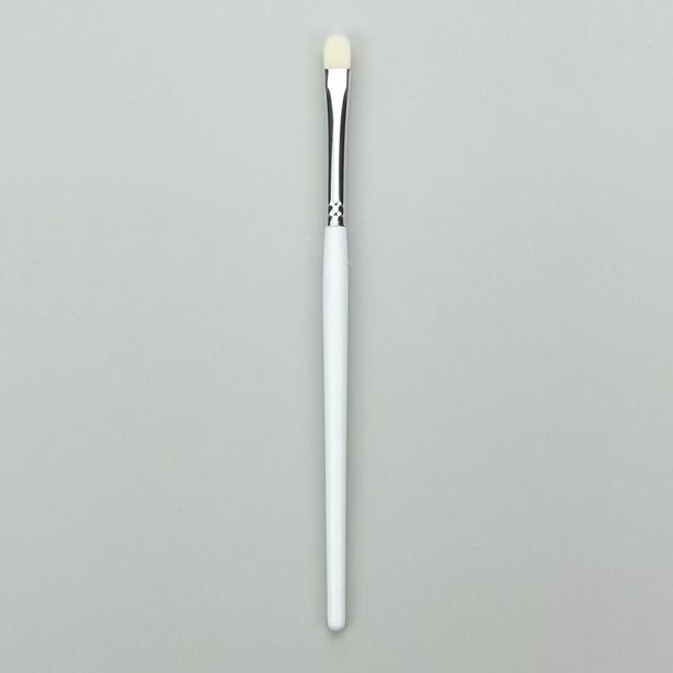 White-handle brush with a narrow rounded-flat pale head