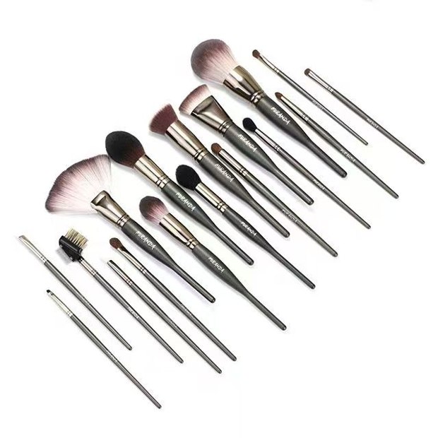 Seventeen dark-gray tools with varied brush heads and a comb