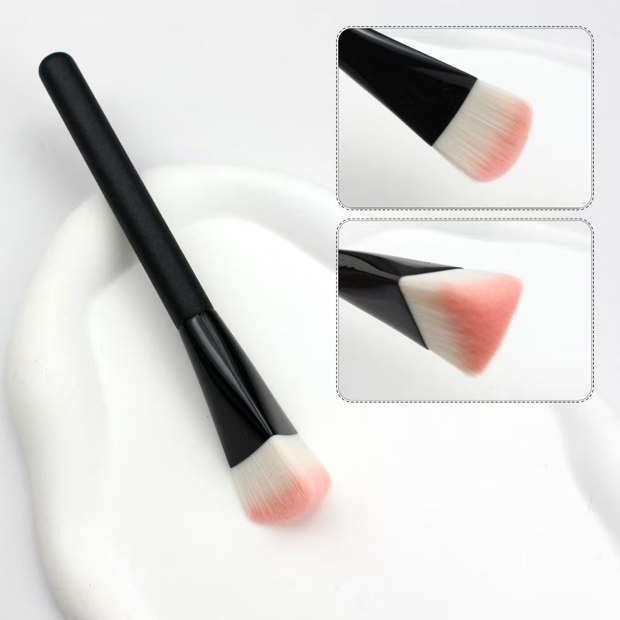 Black handle with a rounded pale head and pink tips