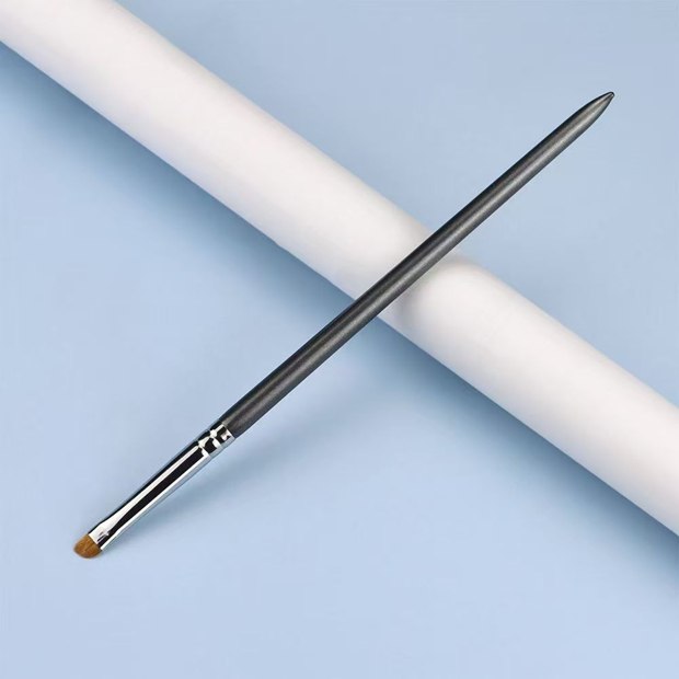 Slim gray handle and silver-tone ferrule with a small ochre-brown flat head