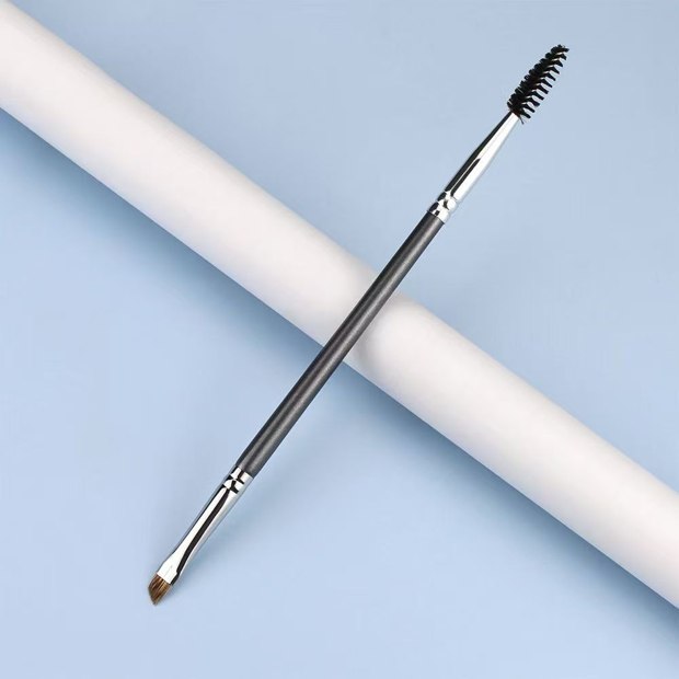 Gray dual-ended brush with an angled brown head and black spoolie
