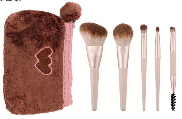 Brown heart pouch with five pink handle brushes