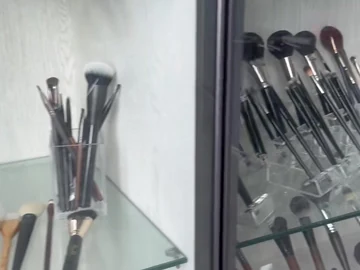 Brush samples on glass cabinet shelves