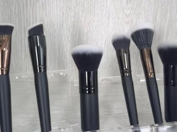 Black-handle brushes above a row of slim handles
