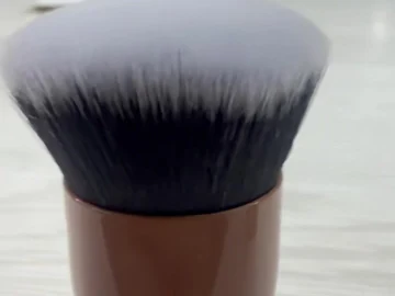 Close view of a brown compact brush