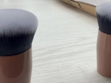Two brown compact brushes on the table