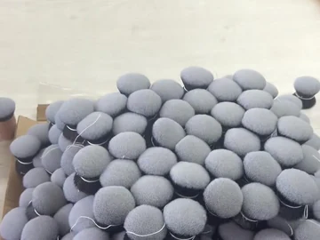 Rows of round grey brush heads on the table