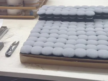Round brush-head trays near stacked cartons