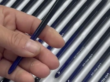 Blue-handle detail brushes beside a sample tray