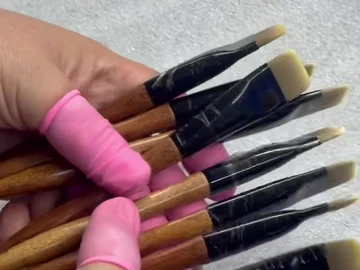 Pink handles and flat black ferrules in hand