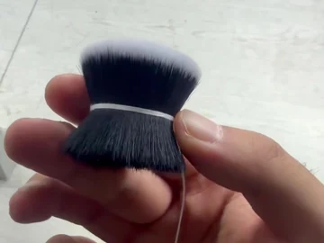 Two loose brush heads compared in hand