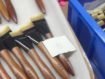 Close view of the tray of long-handle brushes