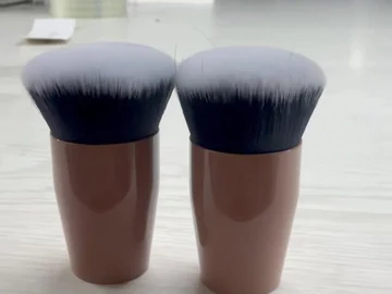 Two flat-top compact brushes standing together
