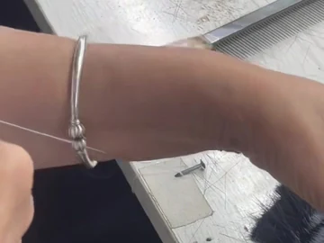 Fine thread drawn across the brush work area