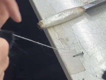 Thread and brush-making tools on the work mat