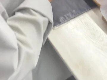 Close view of the small component held at the bench