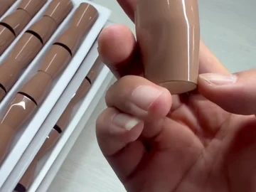 Side view of the brown brush body in hand