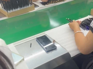 Operators facing each other across the workbench