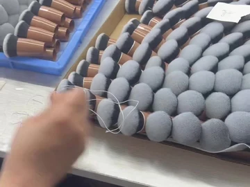 Brush-head tray beside brown compact bodies