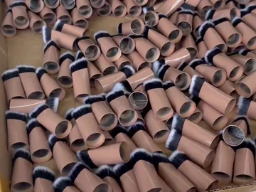 Brown compact brushes grouped on a lined table