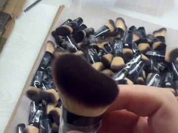 Side profile of the angled compact brush in hand