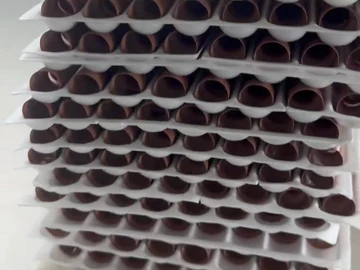 Stacked white inserts containing brown brush bodies