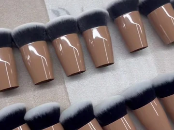 Compact brushes aligned on a light surface
