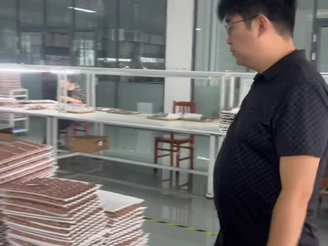 Workshop aisle beside stacked brush trays